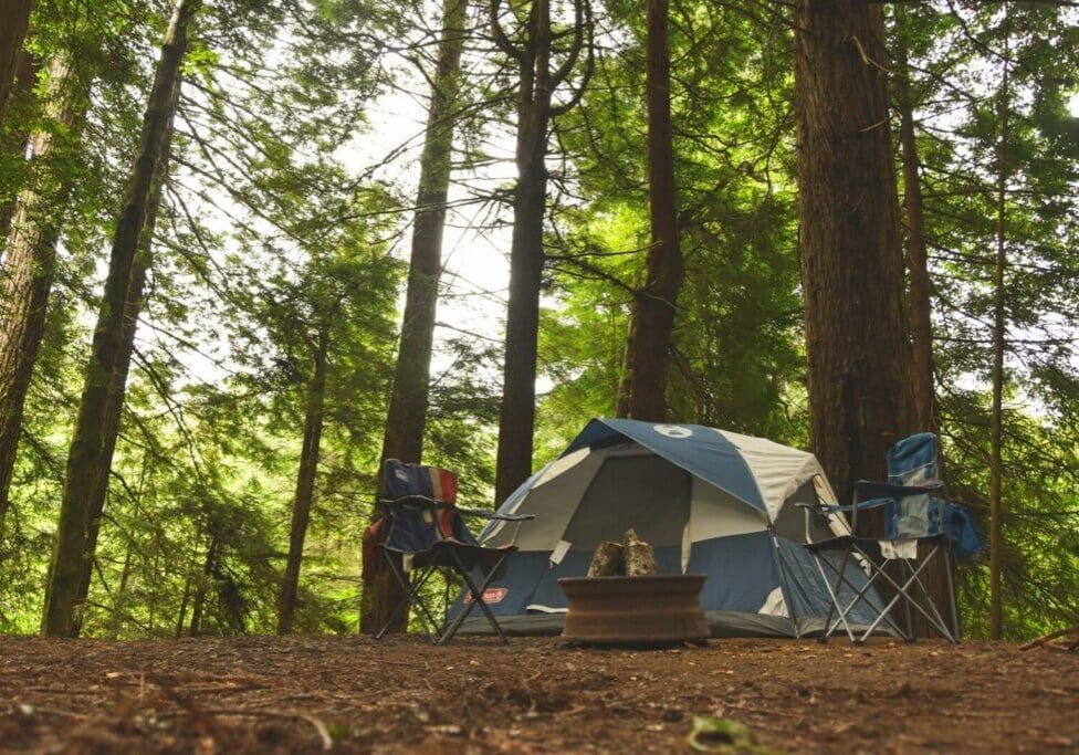 two blue camping chairs near camping tent